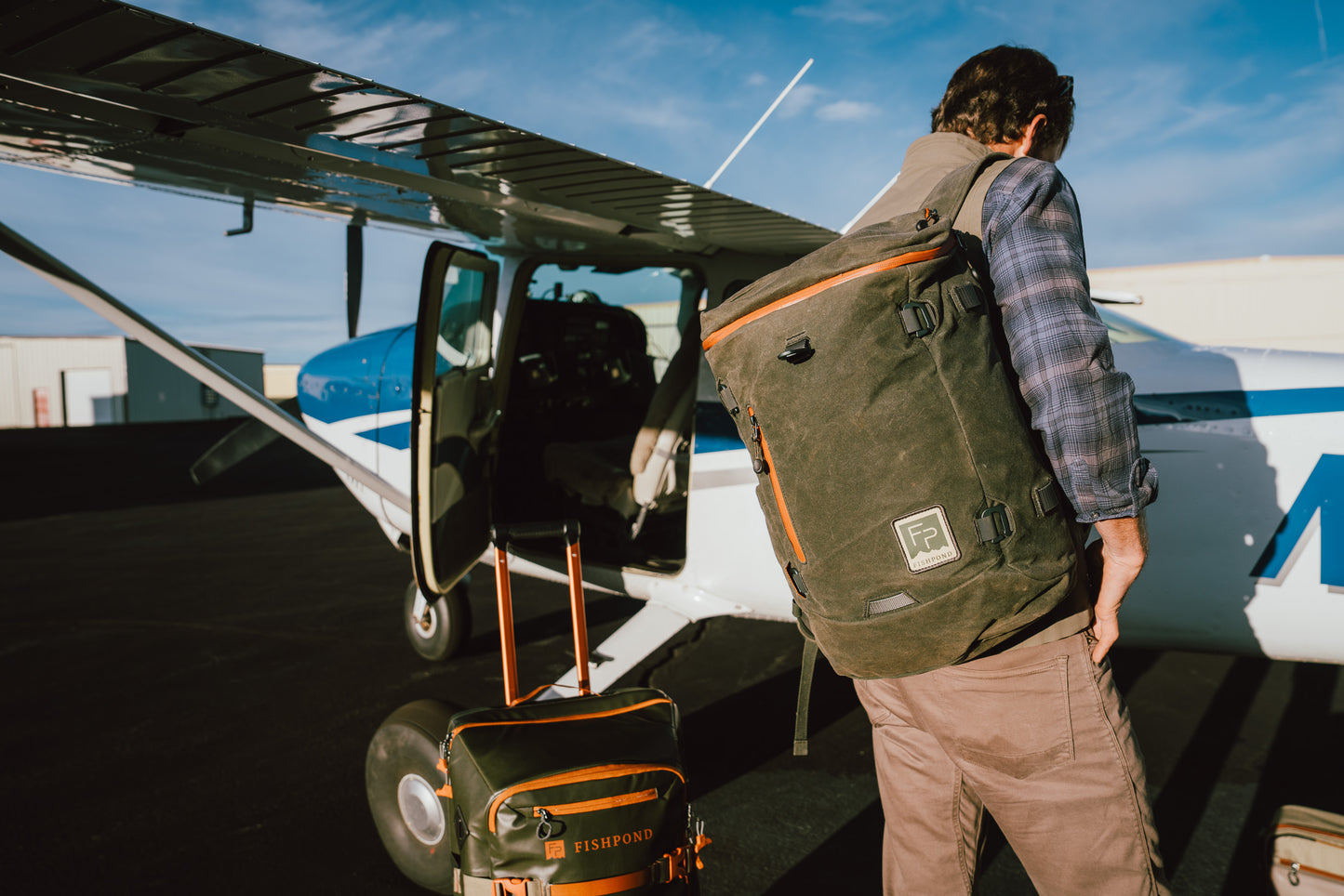 Person with a backpack boarding a small airplane